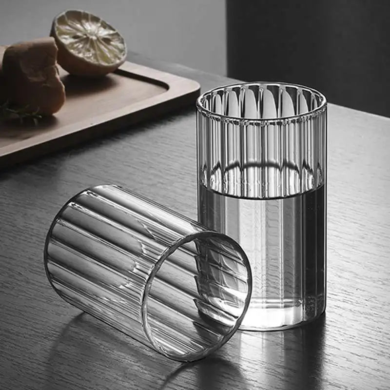 Modern ridged glass tumbler with vertical stripes, heat-resistant glass for hot and cold beverages