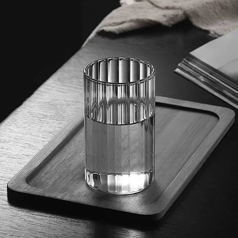 Modern ridged glass tumbler with vertical stripes, heat-resistant glass for hot and cold beverages