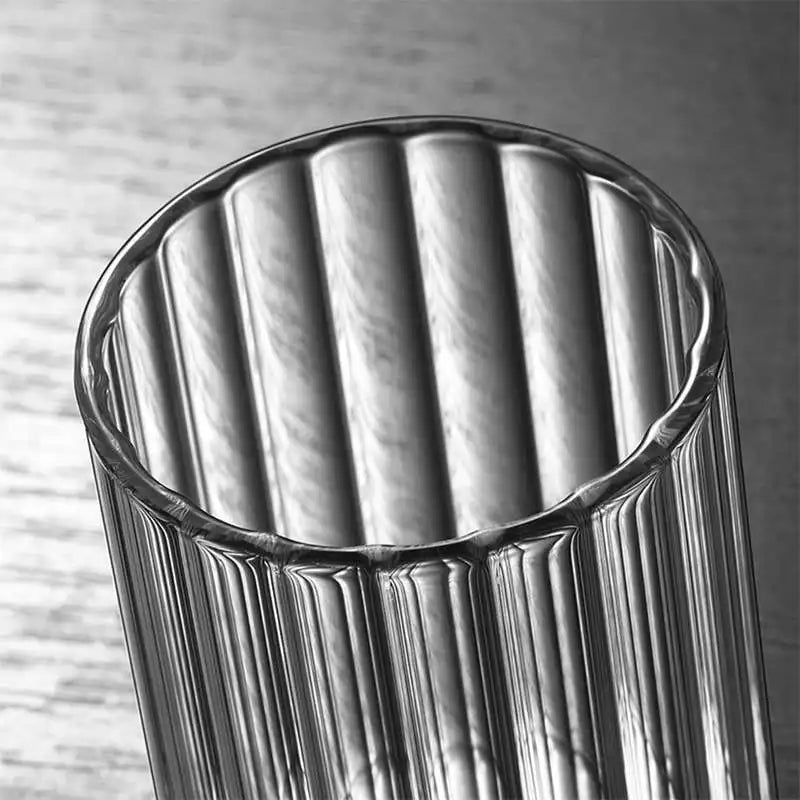 Modern ridged glass tumbler with vertical stripes, heat-resistant glass for hot and cold beverages