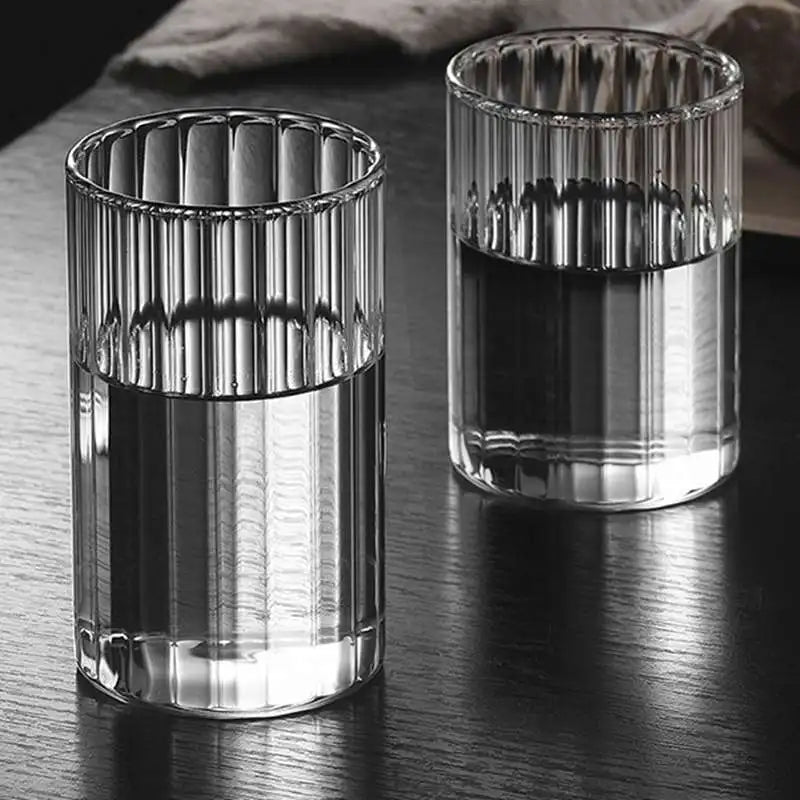 Modern ridged glass tumbler with vertical stripes, heat-resistant glass for hot and cold beverages