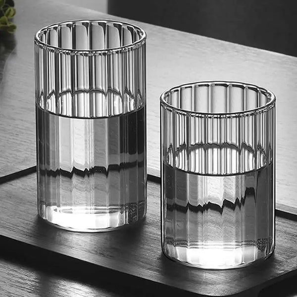 Modern ridged glass tumbler with vertical stripes, heat-resistant glass for hot and cold beverages