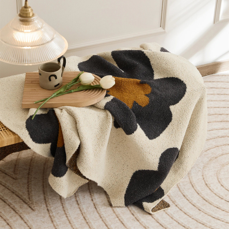 Floral microfiber knit throw blanket with a plush, modern design, anti-pilling, and wearable comfort