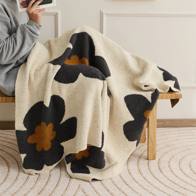 Floral microfiber knit throw blanket with a plush, modern design, anti-pilling, and wearable comfort