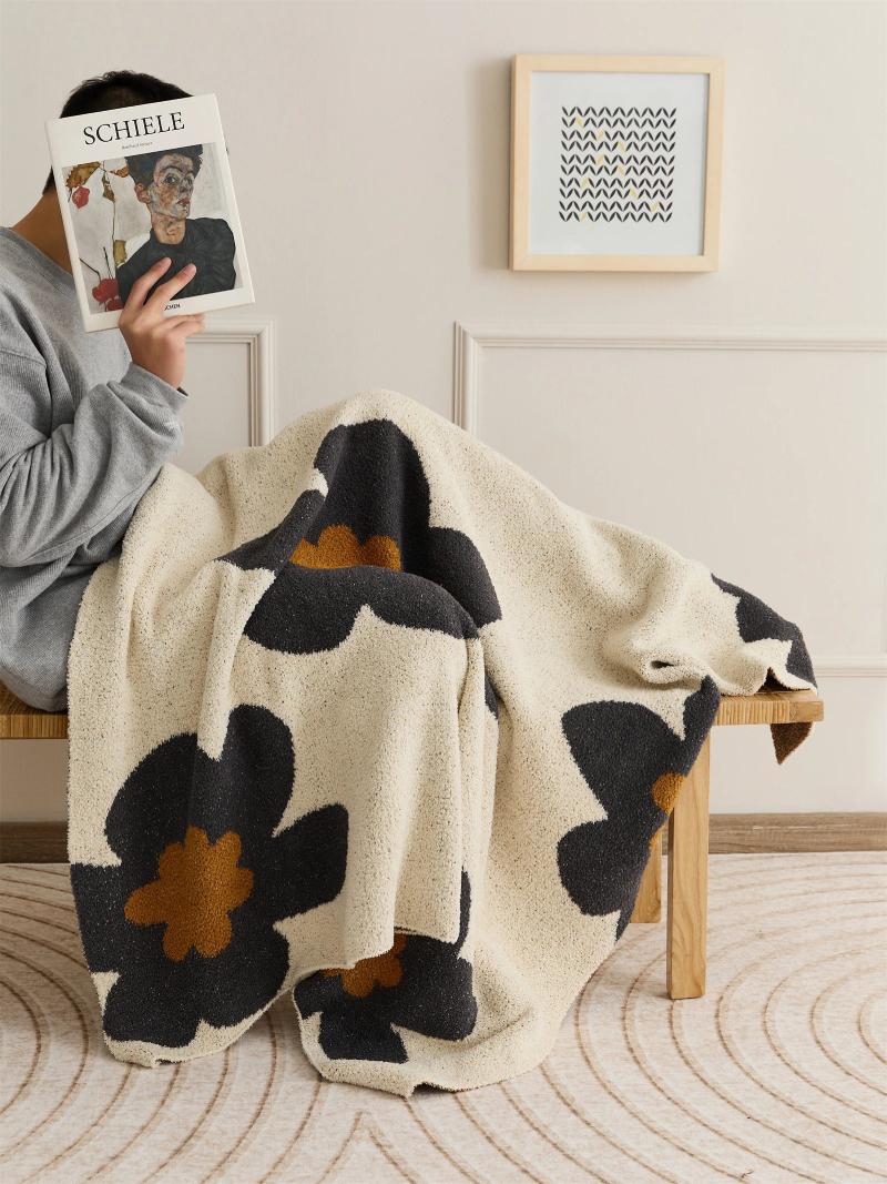 Floral microfiber knit throw blanket with a plush, modern design, anti-pilling, and wearable comfort