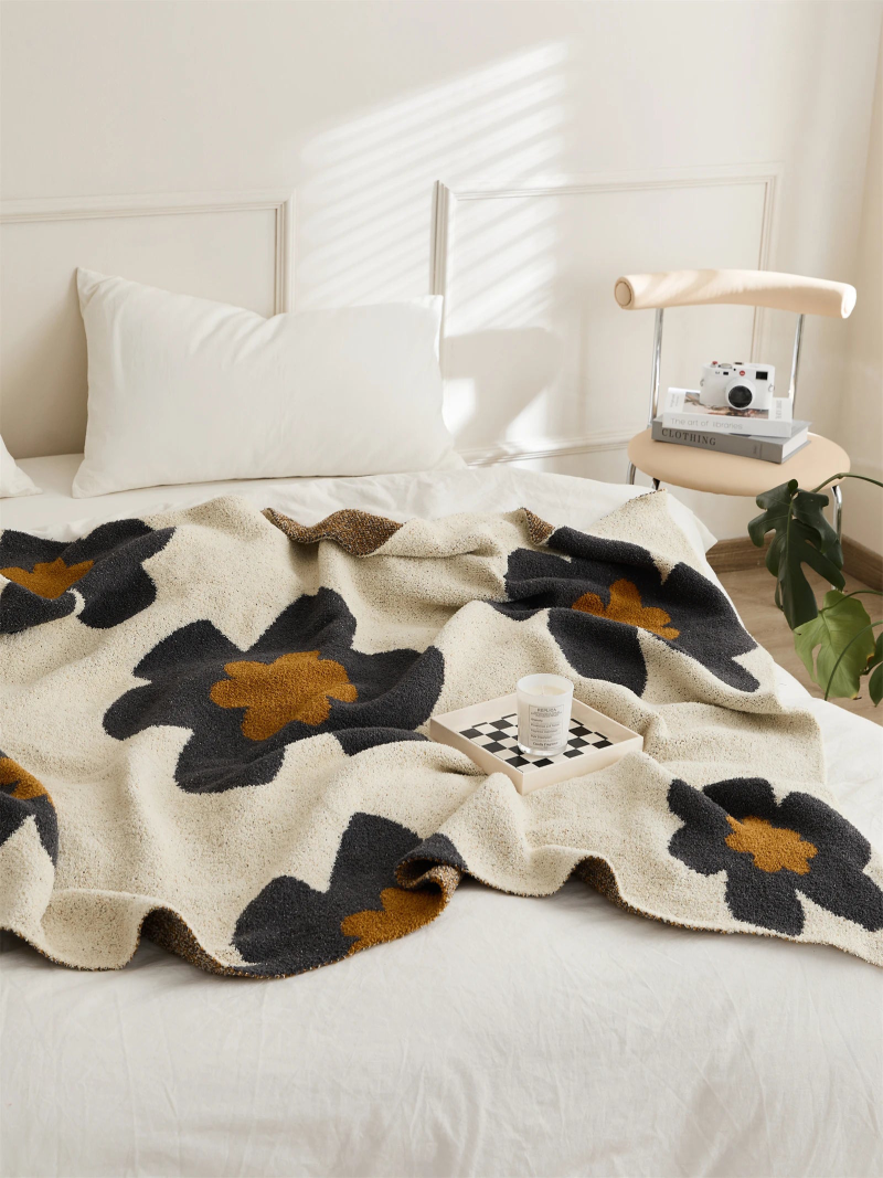 Floral microfiber knit throw blanket with a plush, modern design, anti-pilling, and wearable comfort