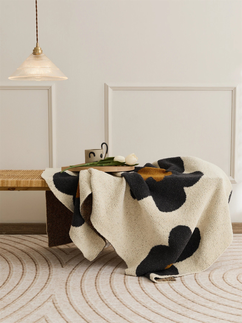 Floral microfiber knit throw blanket with a plush, modern design, anti-pilling, and wearable comfort