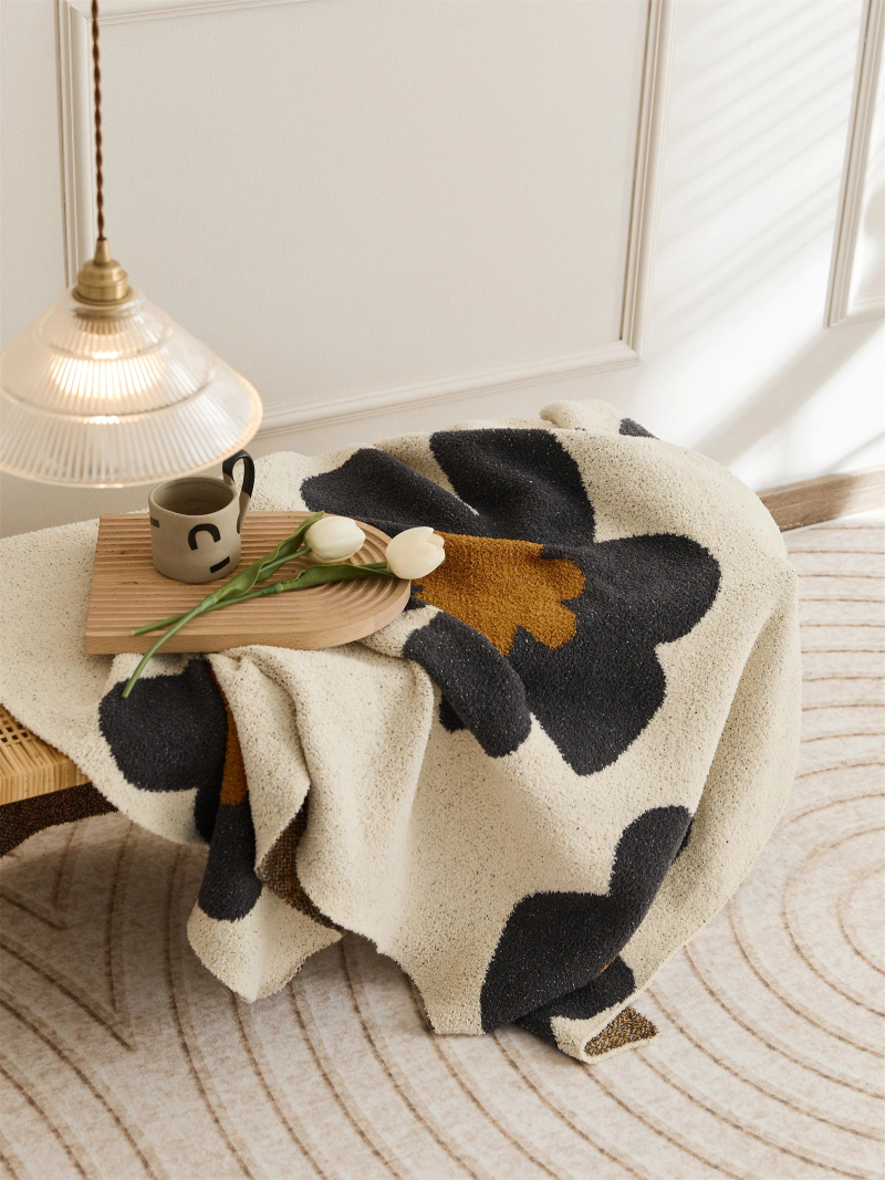 Floral microfiber knit throw blanket with a plush, modern design, anti-pilling, and wearable comfort