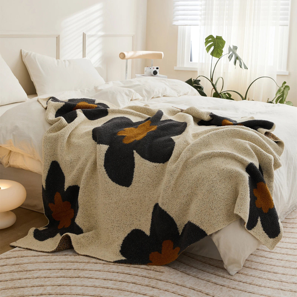 Floral microfiber knit throw blanket with a plush, modern design, anti-pilling, and wearable comfort