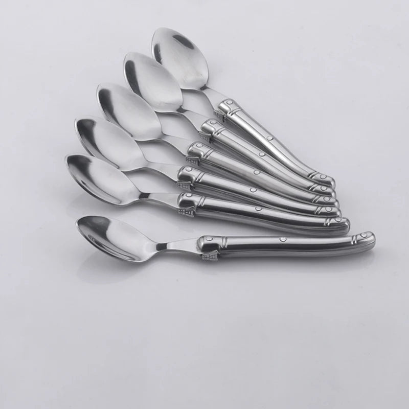 Elegant stainless steel flatware set with a polished finish, ergonomic handles, and precision steak knives