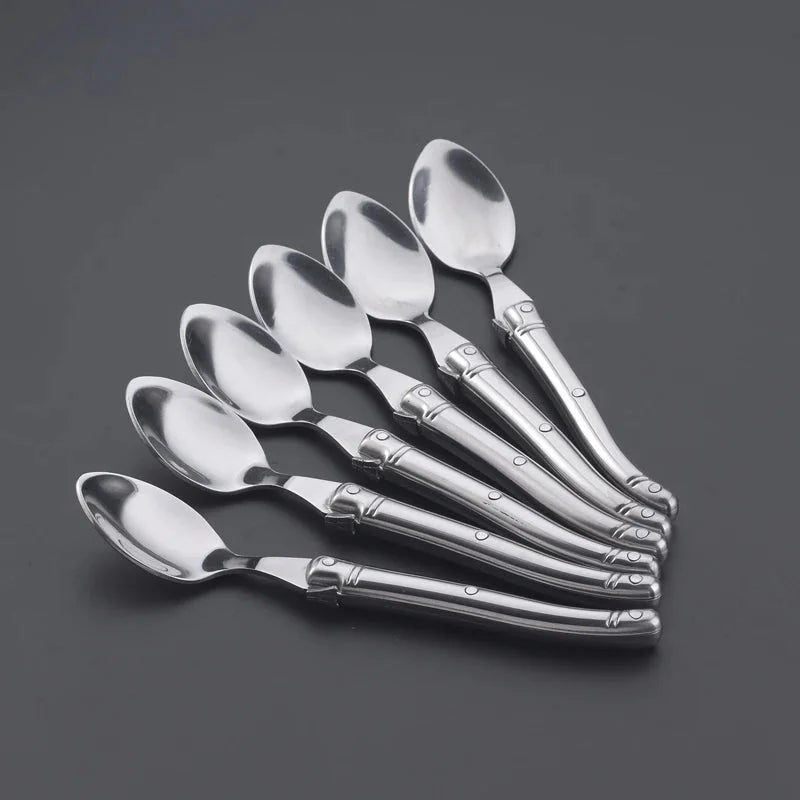 Elegant stainless steel flatware set with a polished finish, ergonomic handles, and precision steak knives