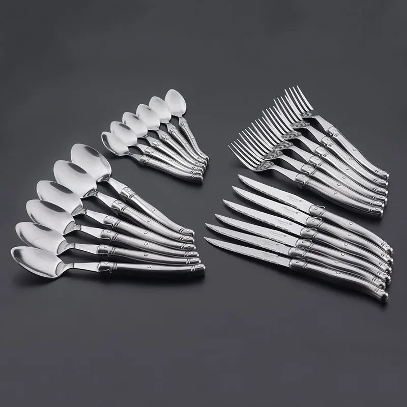 Elegant stainless steel flatware set with a polished finish, ergonomic handles, and precision steak knives