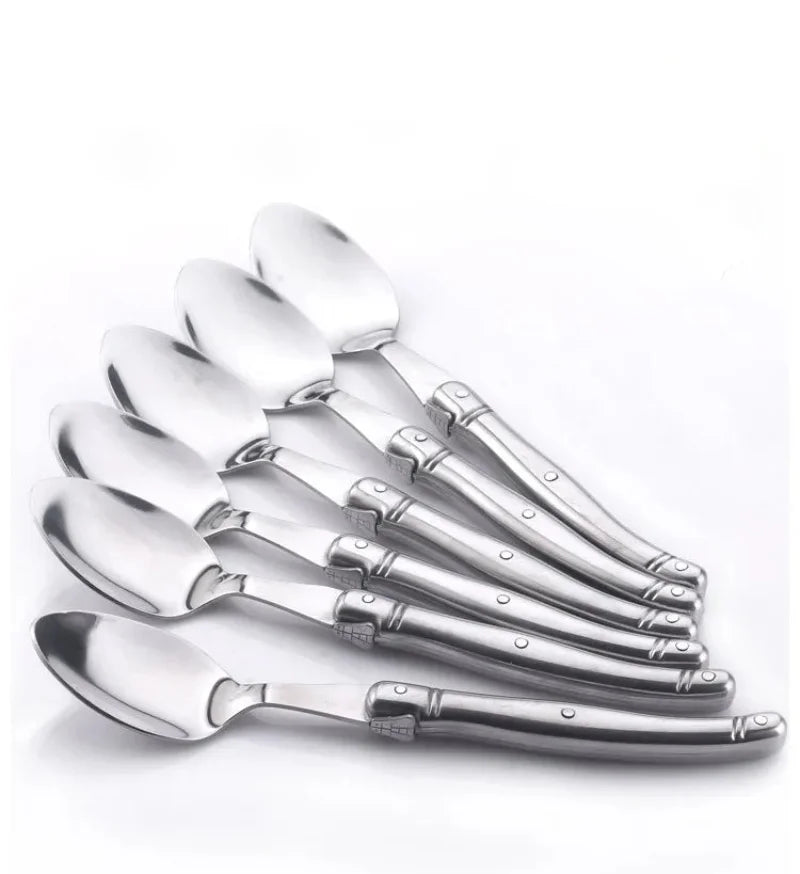 Elegant stainless steel flatware set with a polished finish, ergonomic handles, and precision steak knives