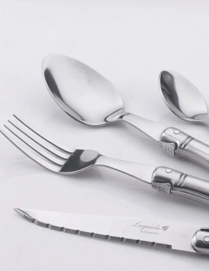 Elegant stainless steel flatware set with a polished finish, ergonomic handles, and precision steak knives