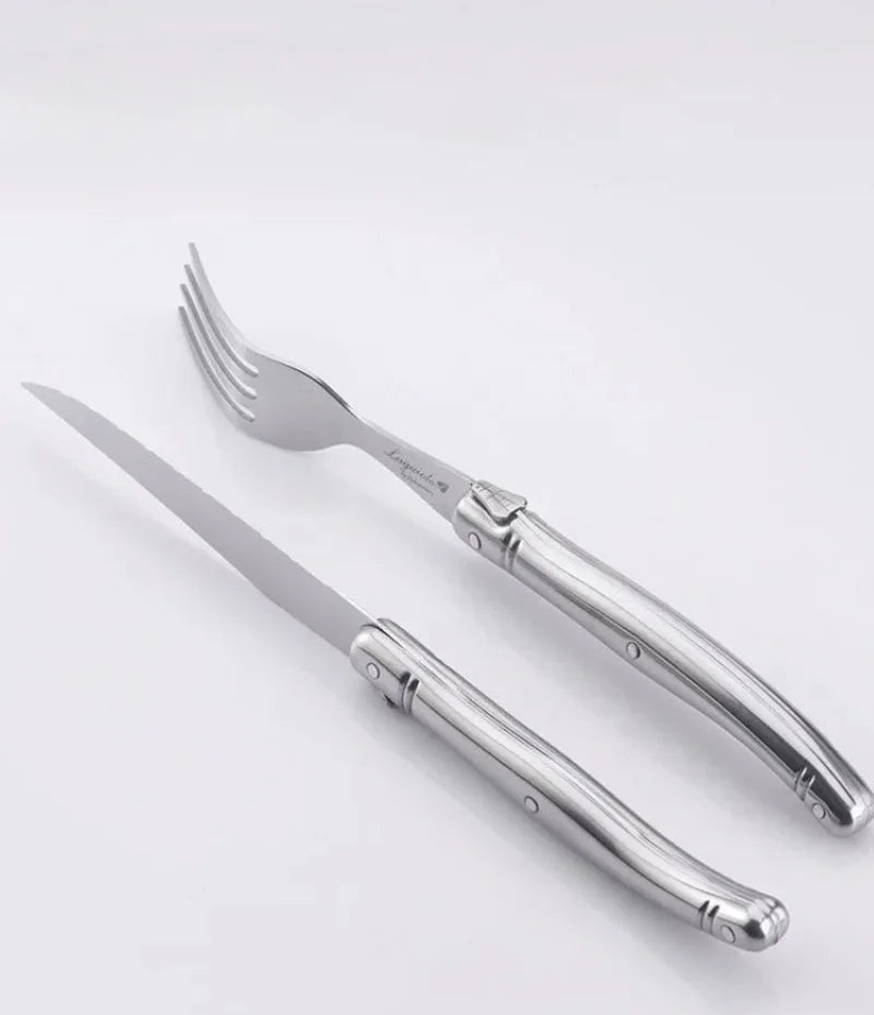 Elegant stainless steel flatware set with a polished finish, ergonomic handles, and precision steak knives