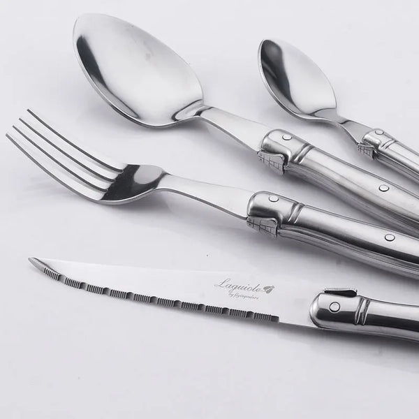 Elegant stainless steel flatware set with a polished finish, ergonomic handles, and precision steak knives