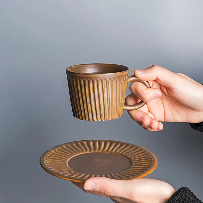 Handcrafted ceramic coffee cup and saucer set with vertical grain texture, and speckled glazed finish