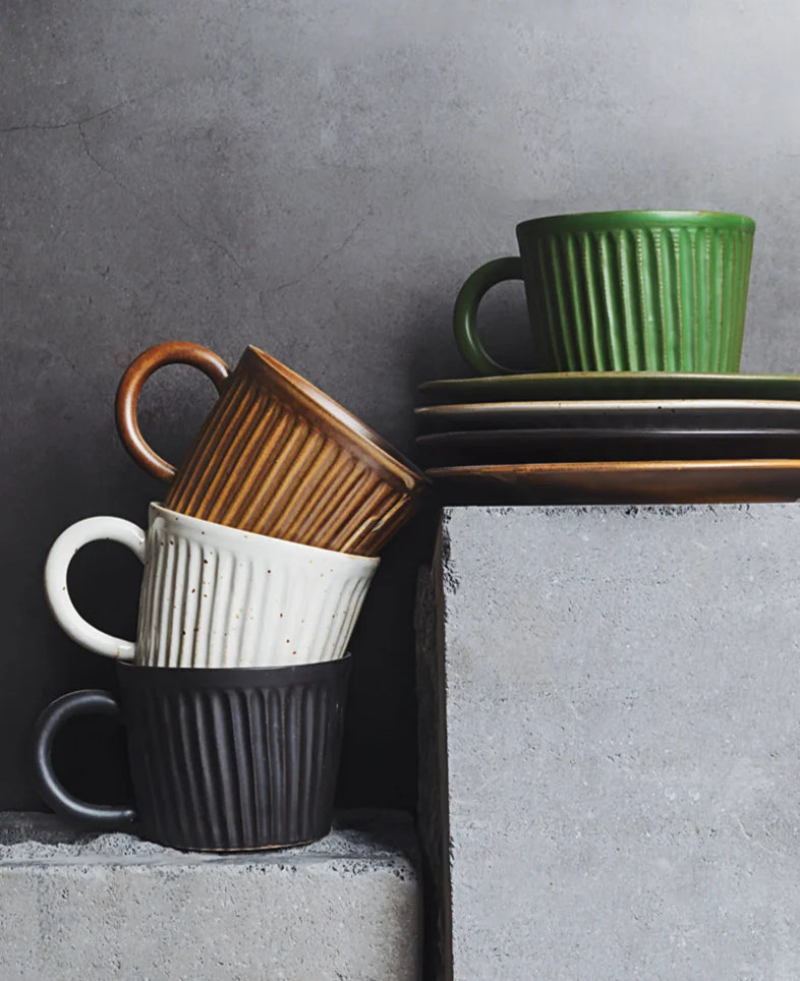 Handcrafted ceramic coffee cup and saucer set with vertical grain texture, and speckled glazed finish