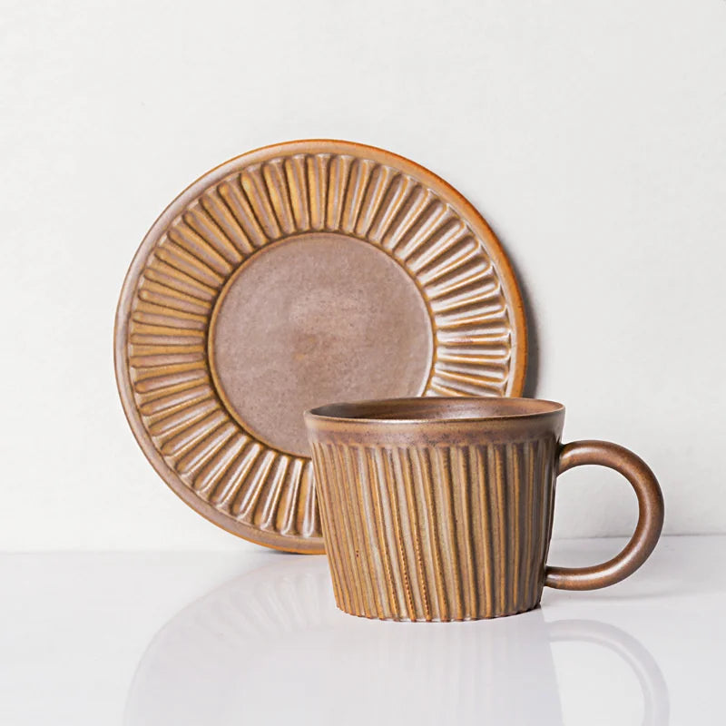 Handcrafted ceramic coffee cup and saucer set with vertical grain texture, and speckled glazed finish