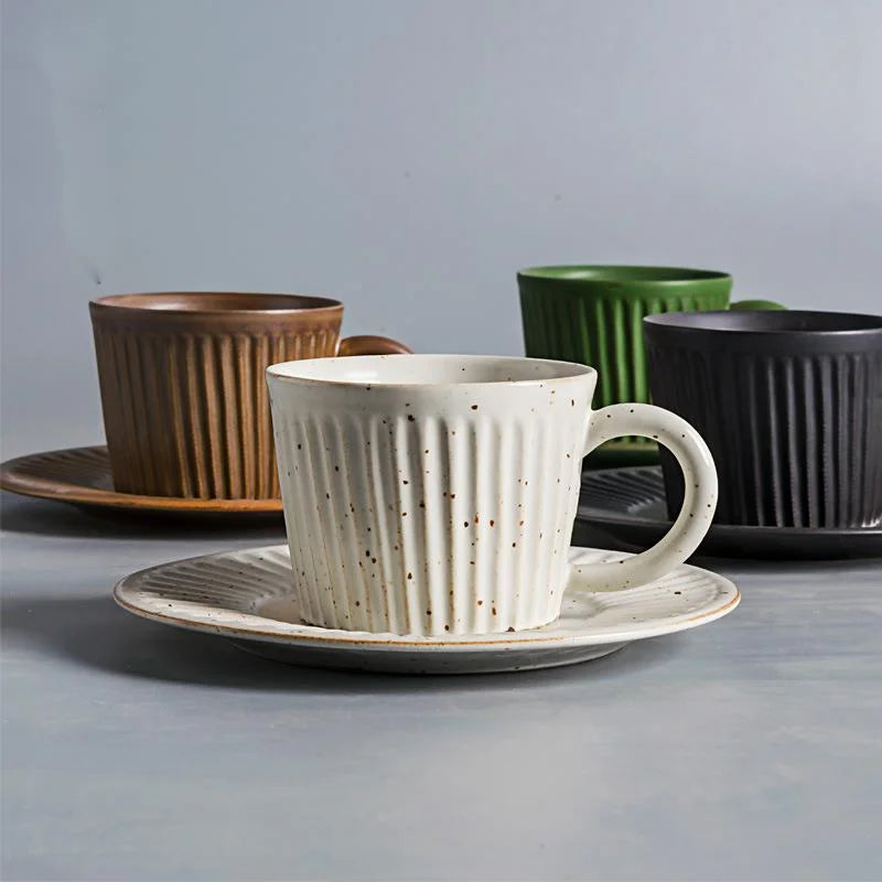 Handcrafted ceramic coffee cup and saucer set with vertical grain texture, and speckled glazed finish