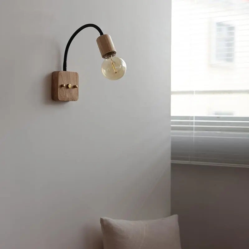 Walnut wood adjustable wall lamp with black arm, minimalist exposed bulb design for modern bedroom or hallway lighting.