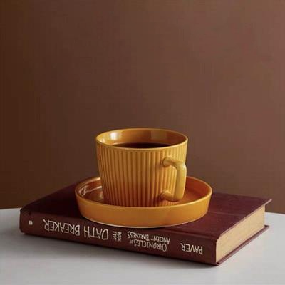 round textured stripe orange ceramic cup with matching saucer