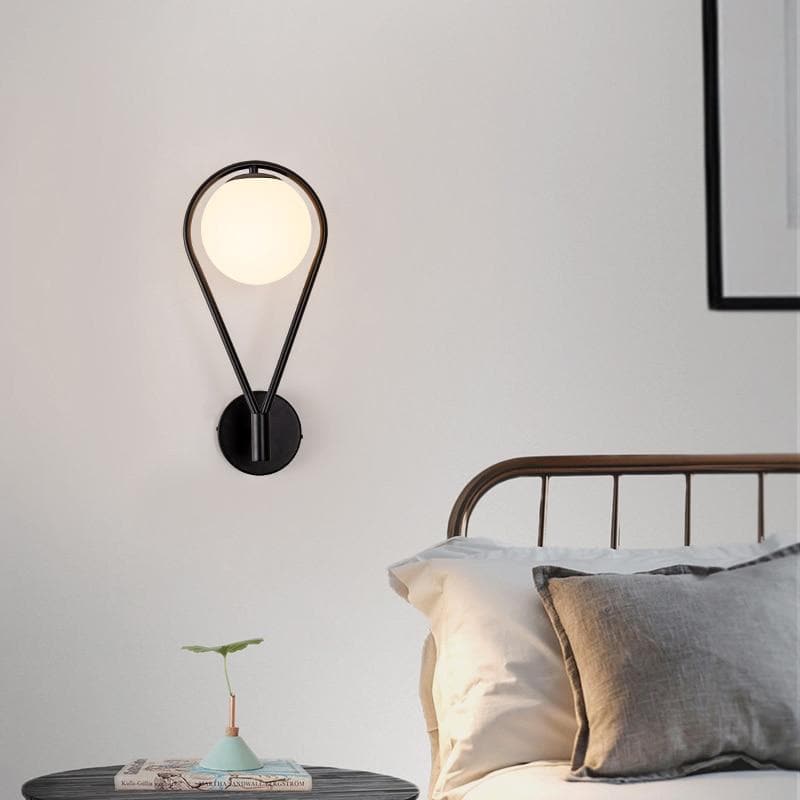 black loop shape wall lamp with a Frosted glass globe 